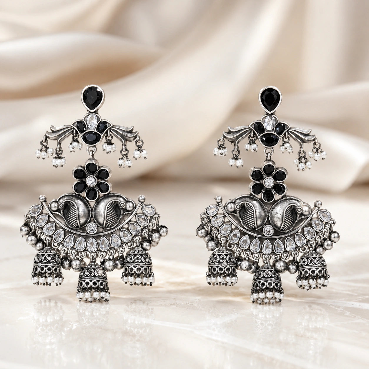 Close-up of black accents, pearl-style beads and antique chandelier detailing