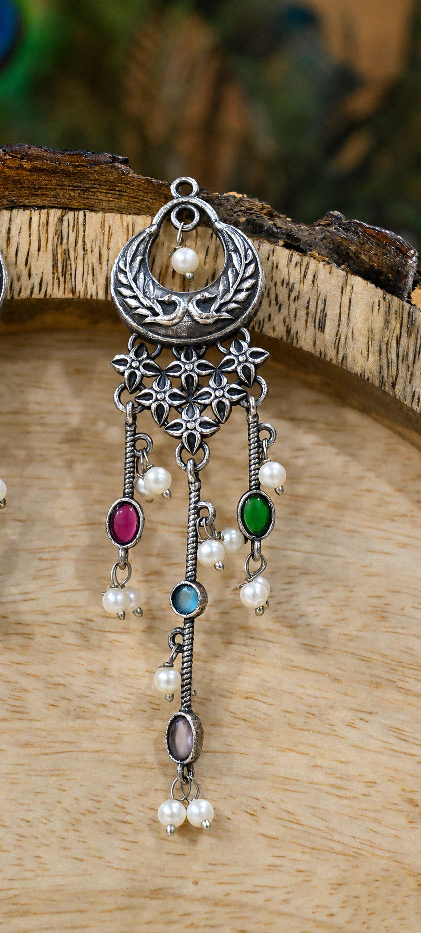 Close-up ear view showing multicolor accents and pearl chandelier layers