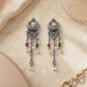 Multicolor pearl chandelier earrings styled in an elegant jewellery flat lay