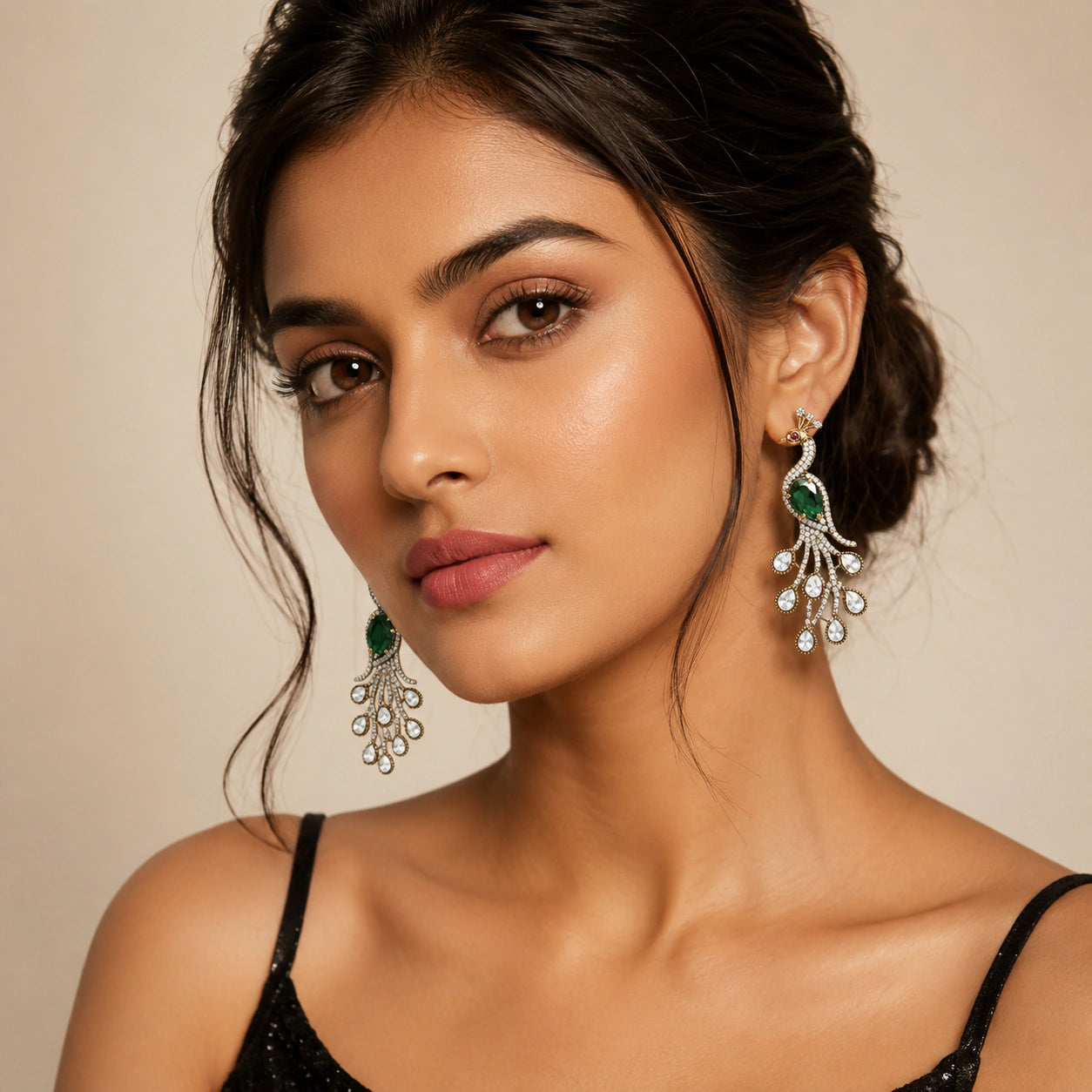 Green peacock chandelier earrings styled in an elegant jewellery flat lay