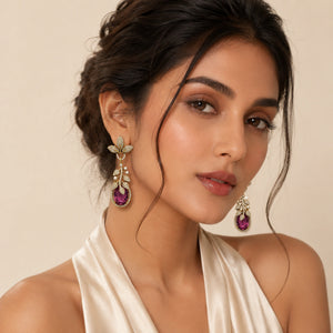Purple leaf chandelier earrings styled in an elegant jewellery flat lay