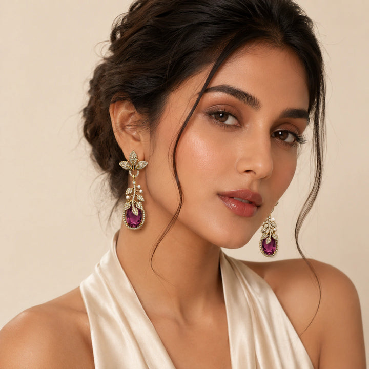 Purple leaf chandelier earrings styled in an elegant jewellery flat lay