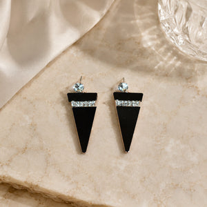 Black rose-gold crystal earrings styled in a modern jewellery flat lay