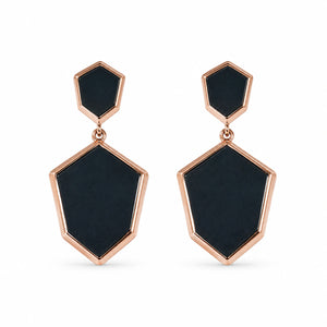 Angled view of black rose-gold geometric drop earrings