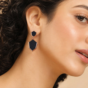 Black rose-gold geometric earrings styled in a modern jewellery flat lay