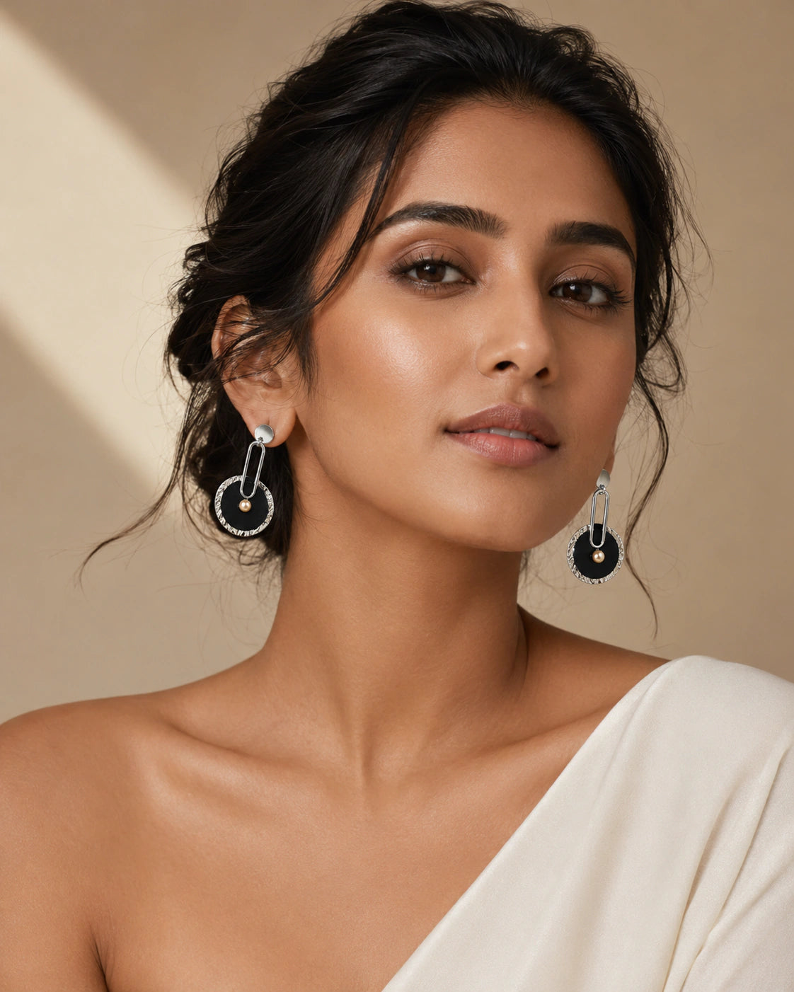 Black silver pearl-style statement earrings worn by a model