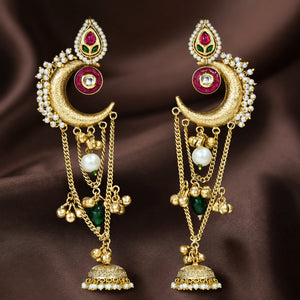 Brass-gold Kundan pearl chandbali jhumka earrings in an elegant jewellery flat lay