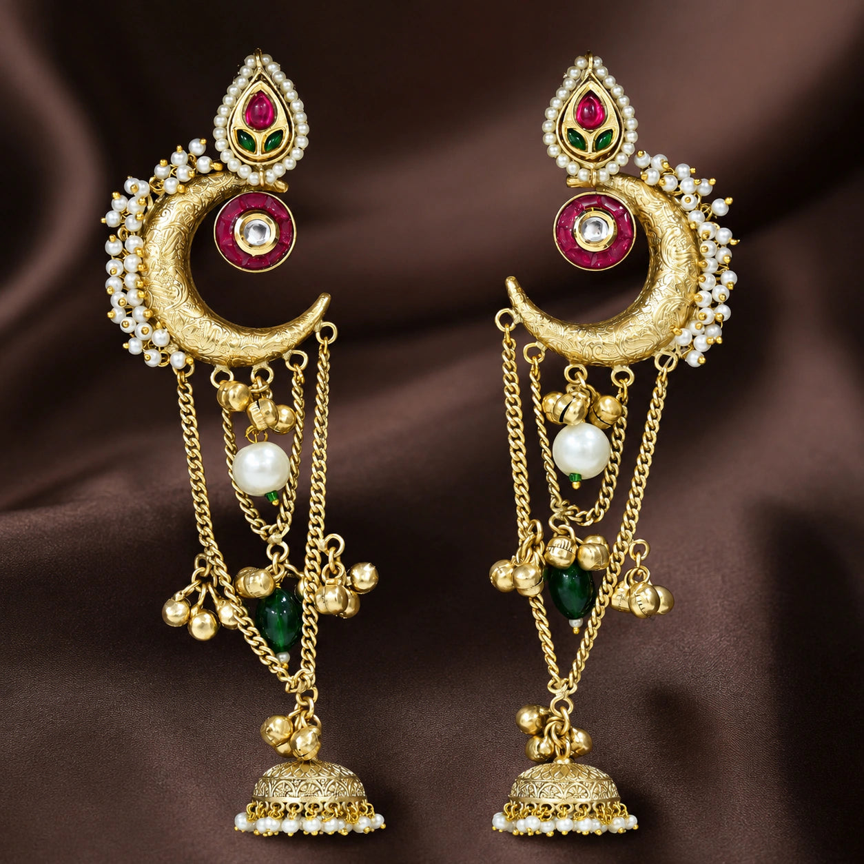Brass-gold Kundan pearl chandbali jhumka earrings in an elegant jewellery flat lay