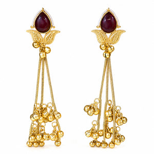Maroon Kundan pearl chandelier earrings styled in an elegant jewellery flat lay