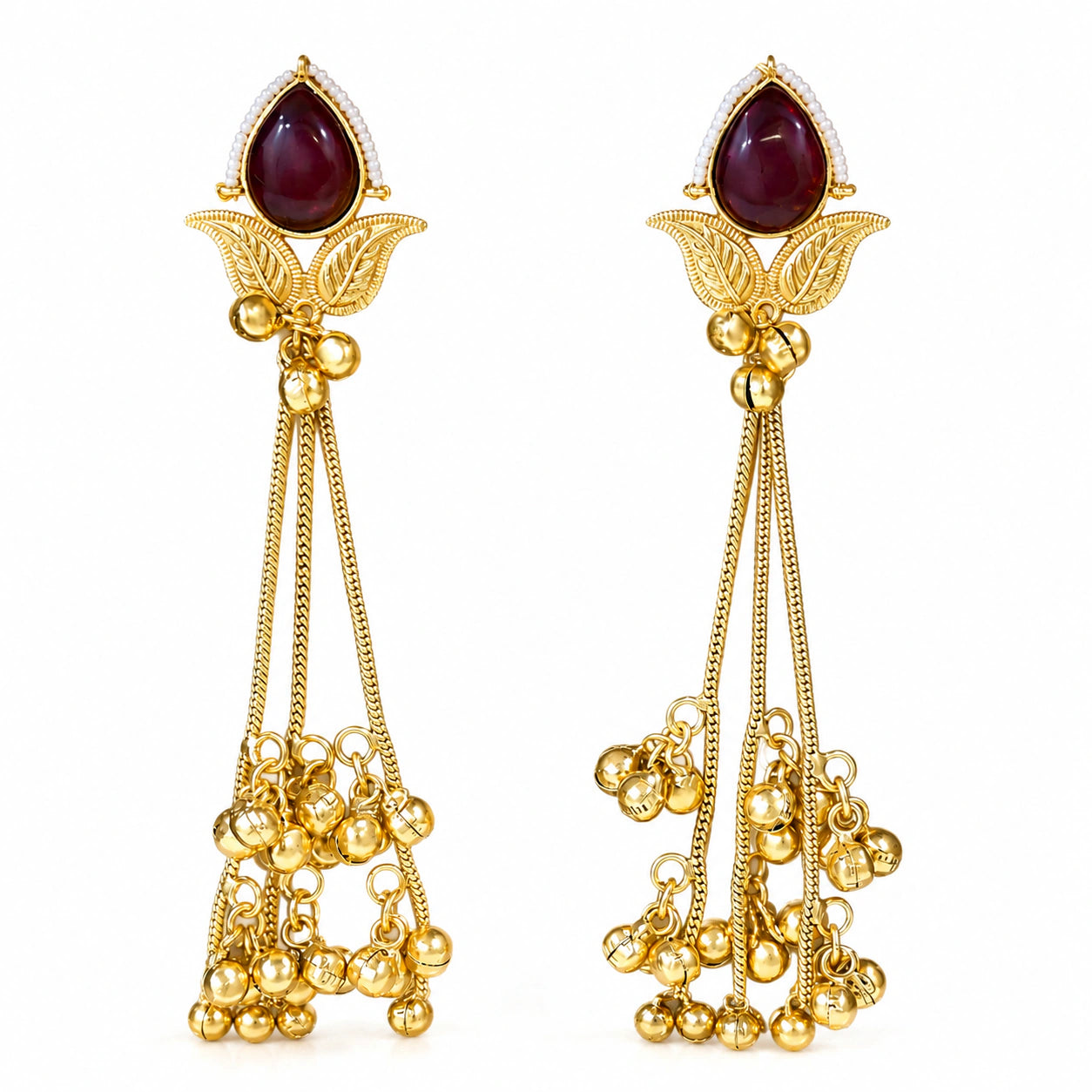 Maroon Kundan pearl chandelier earrings styled in an elegant jewellery flat lay