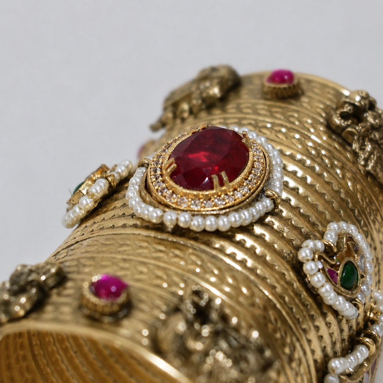 Elephant-motif red Kundan kada styled in an elegant jewellery flat lay