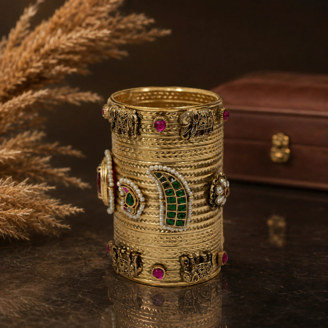Side view of the elephant-motif red Kundan handwork kada