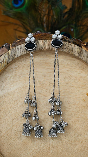 Close-up ear view showing black accents and pearl-style jhumka drops