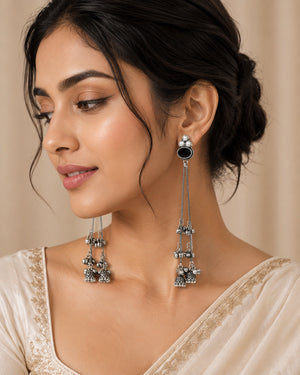 German silver black pearl-style jhumka earrings worn by a model