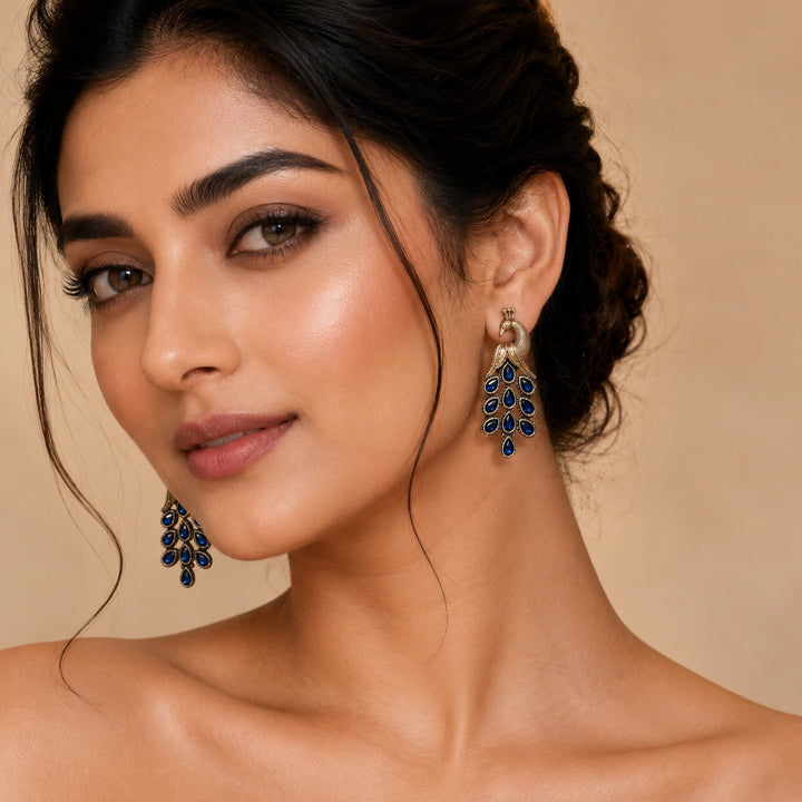 German silver blue-stone peacock chandelier earrings worn by a model