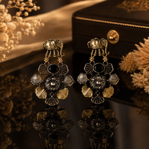Close-up of elephant motifs, black stones and chandelier detailing