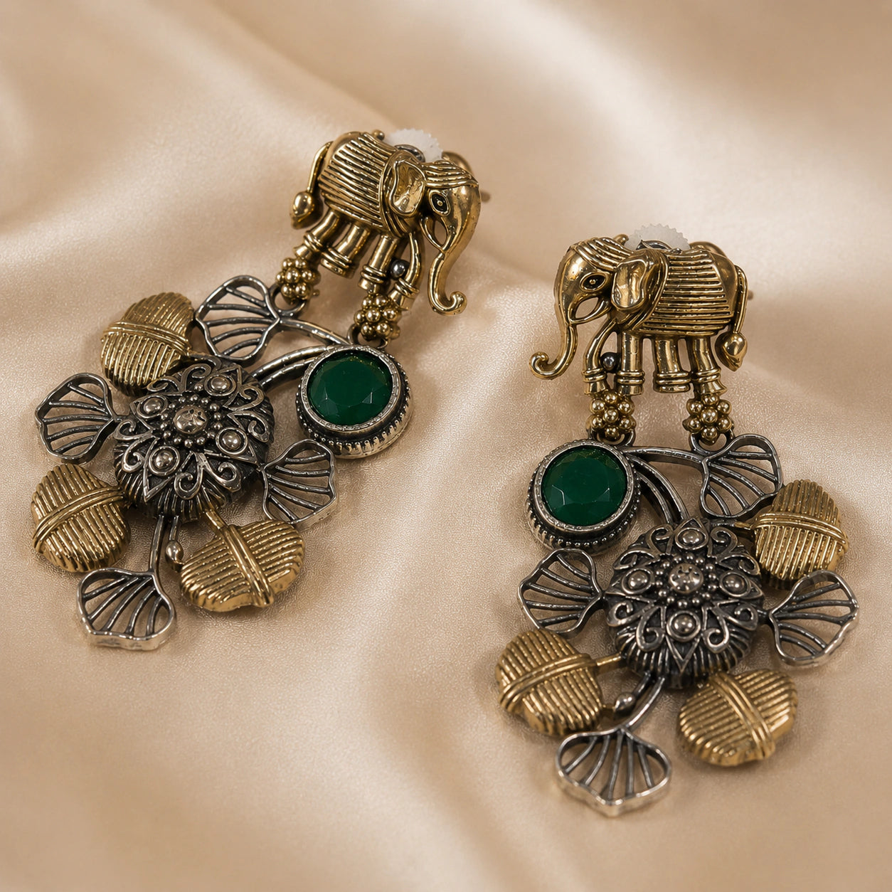 Angled view of German silver elephant green-stone chandelier earrings