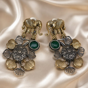 Elephant green-stone chandelier earrings styled in an elegant jewellery flat lay