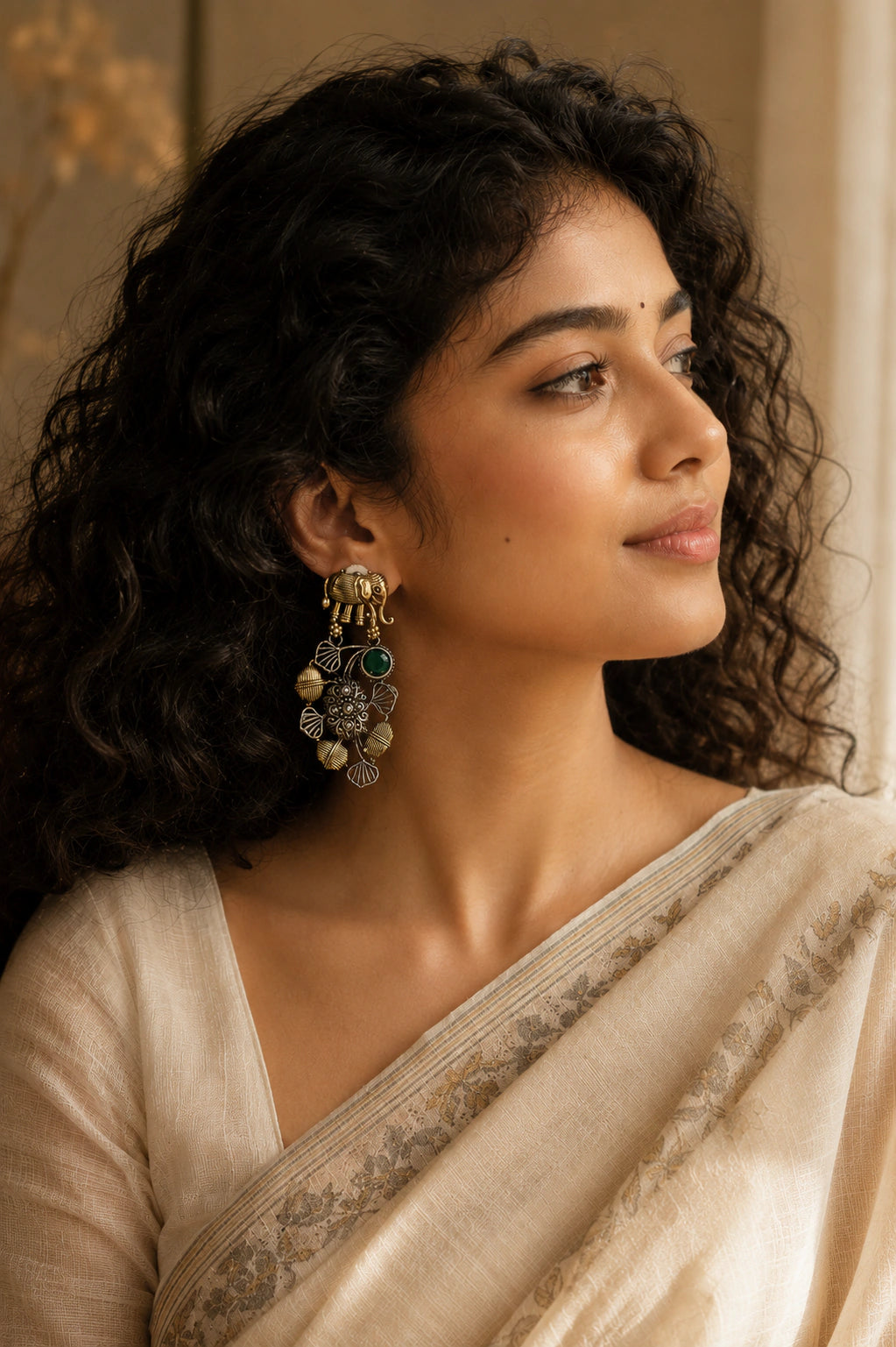 German silver elephant green-stone chandelier earrings worn by a model