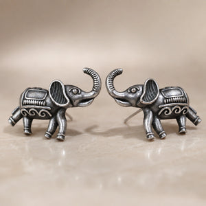 Angled view of German silver antique elephant stud earrings