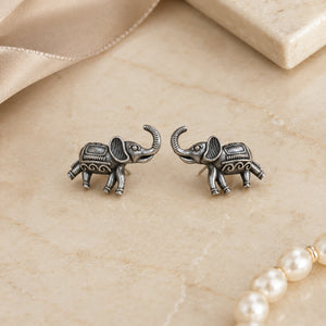 German silver elephant stud earrings styled in an elegant jewellery flat lay