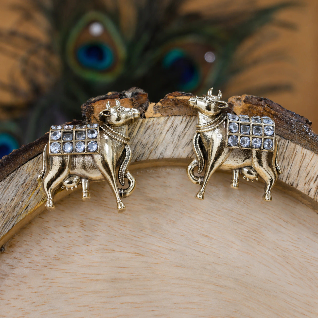 Alternate product view of German silver gold cow-motif crystal drop earrings