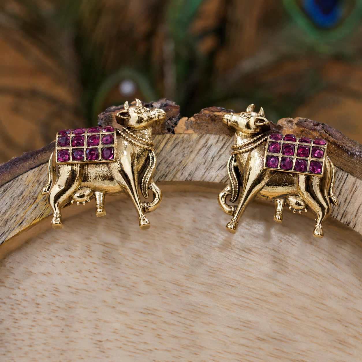 Alternate detail view of gold maroon cow-motif dangle earrings