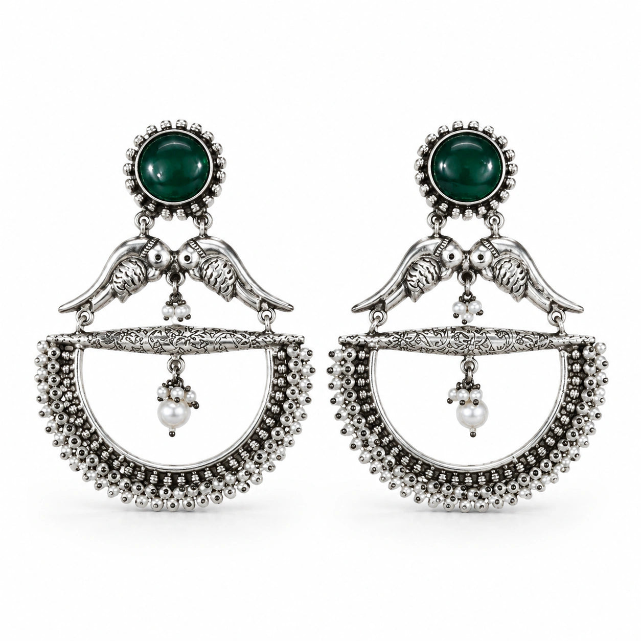 Close-up of green accents, bird motifs and pearl chandelier detailing