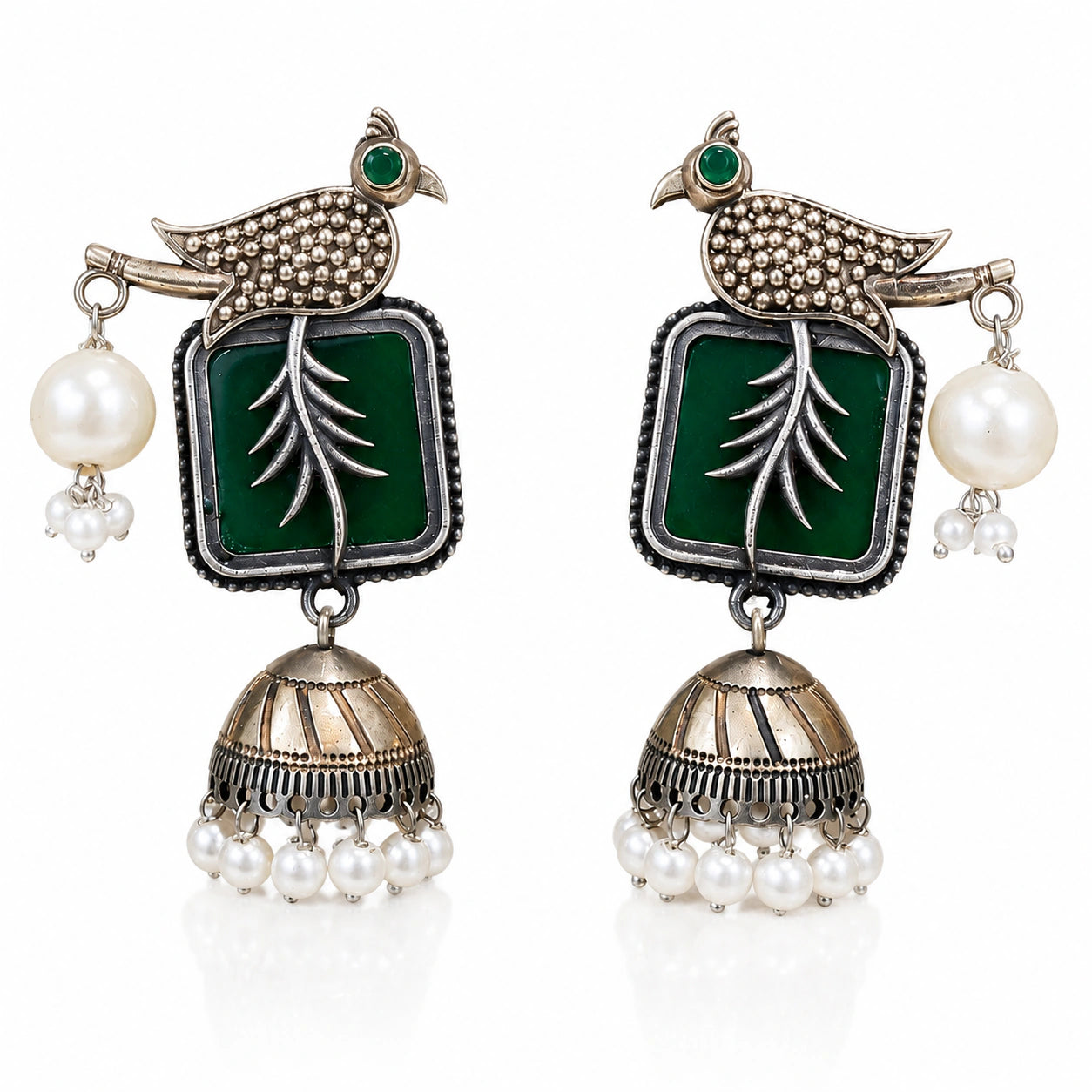 Close-up of green accents, engraved bird motifs and pearl jhumka detailing