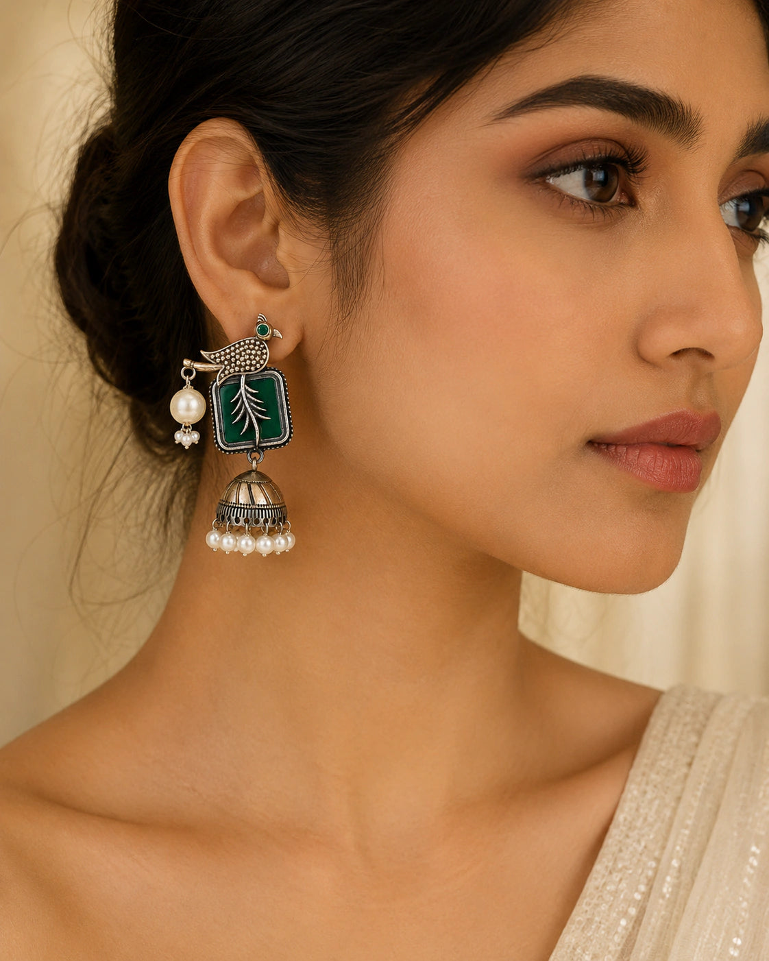 German silver green bird-motif pearl jhumka earrings worn by a model