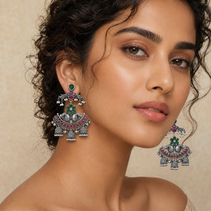 Angled view of German silver green maroon pearl chandelier earrings