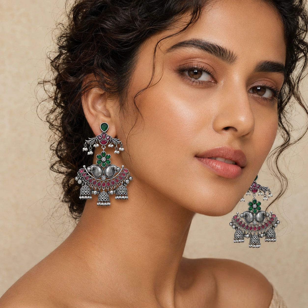 Angled view of German silver green maroon pearl chandelier earrings