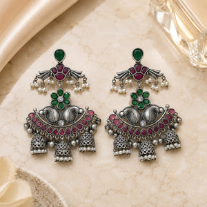 Green maroon pearl chandelier earrings styled in an elegant jewellery flat lay