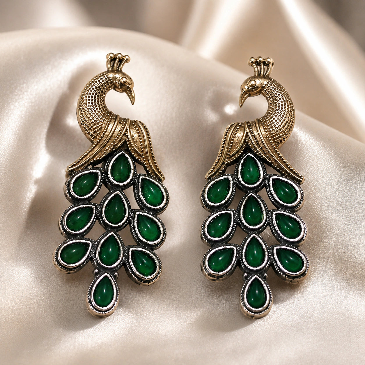 Angled view of German silver green peacock chandelier earrings