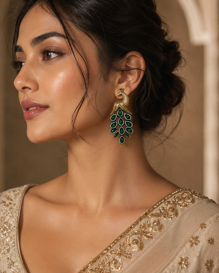 German silver green peacock chandelier earrings worn by a model