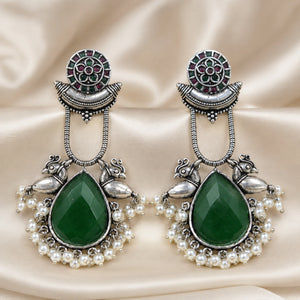 Close-up of green accents, pearl-style beads and German silver bird motifs