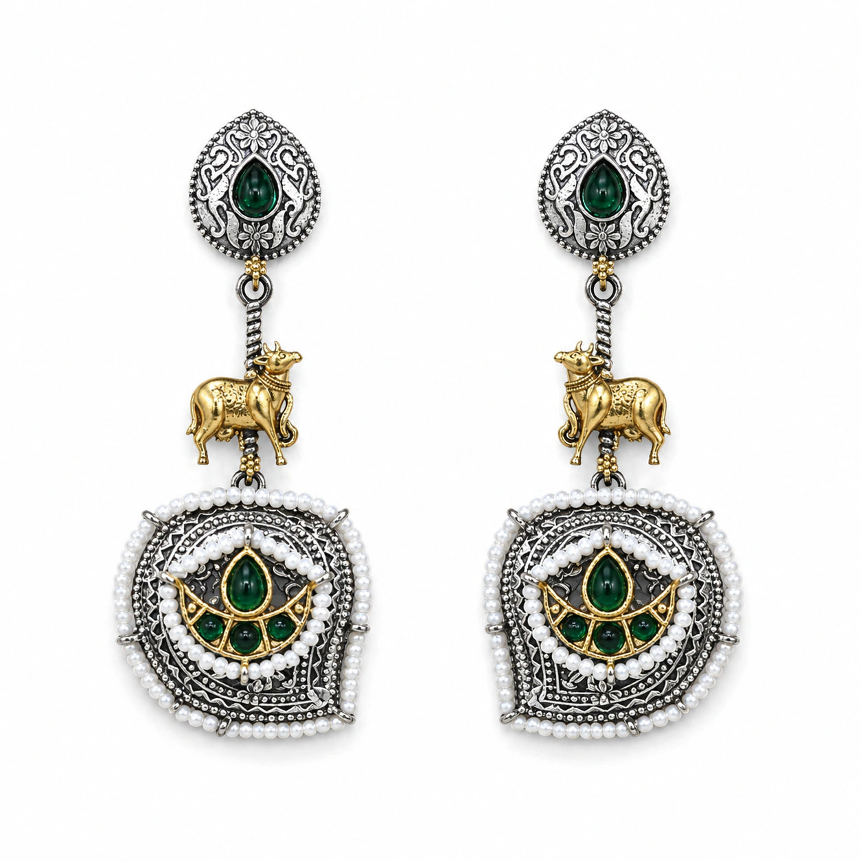 Angled view of German silver green pearl-style cow-motif earrings