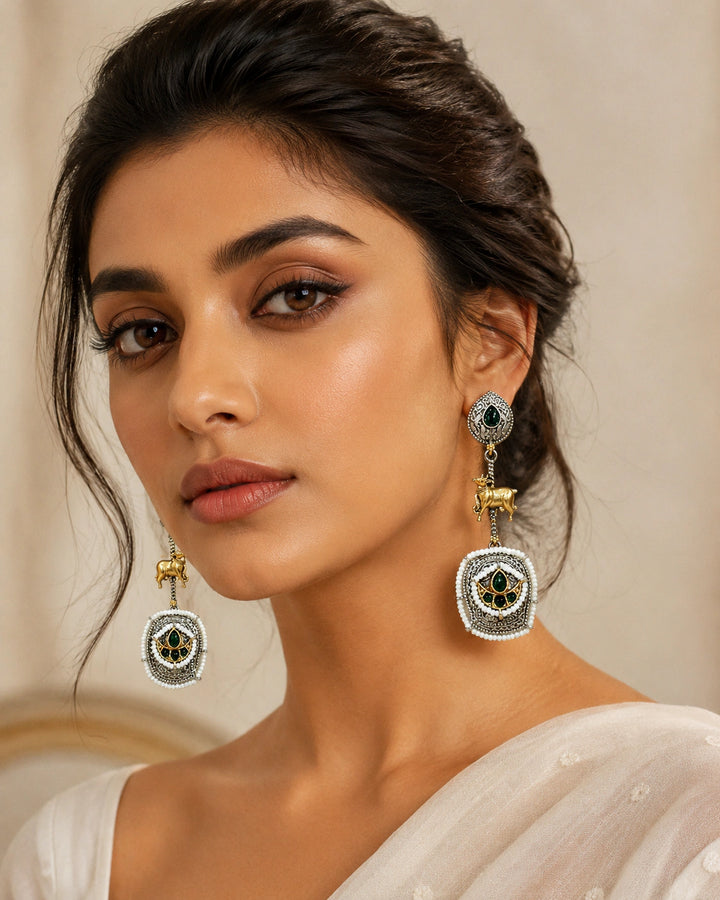 German silver green pearl-style cow-motif earrings worn by a model