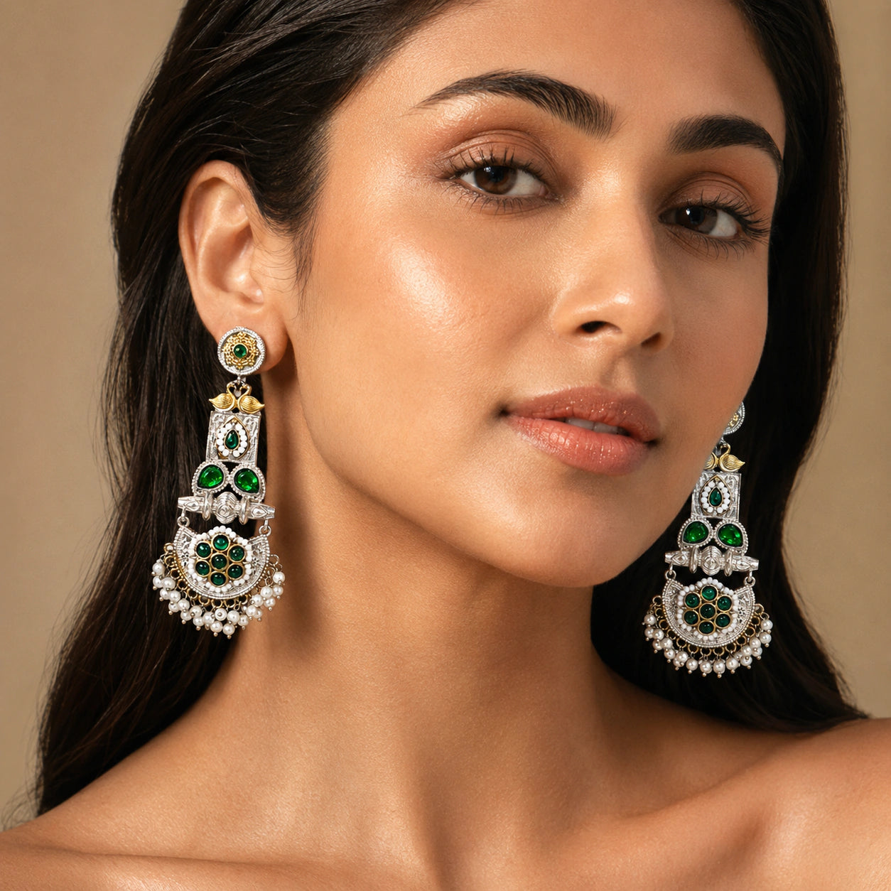 Angled view of German silver green pearl peacock chandelier earrings