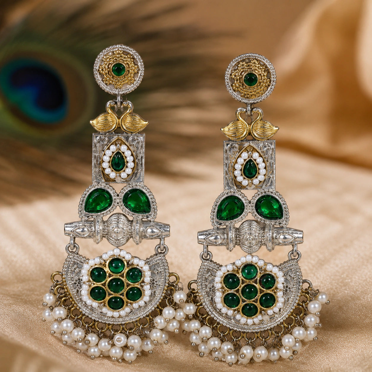 Close-up of green accents, peacock motifs and pearl-style chandelier detailing