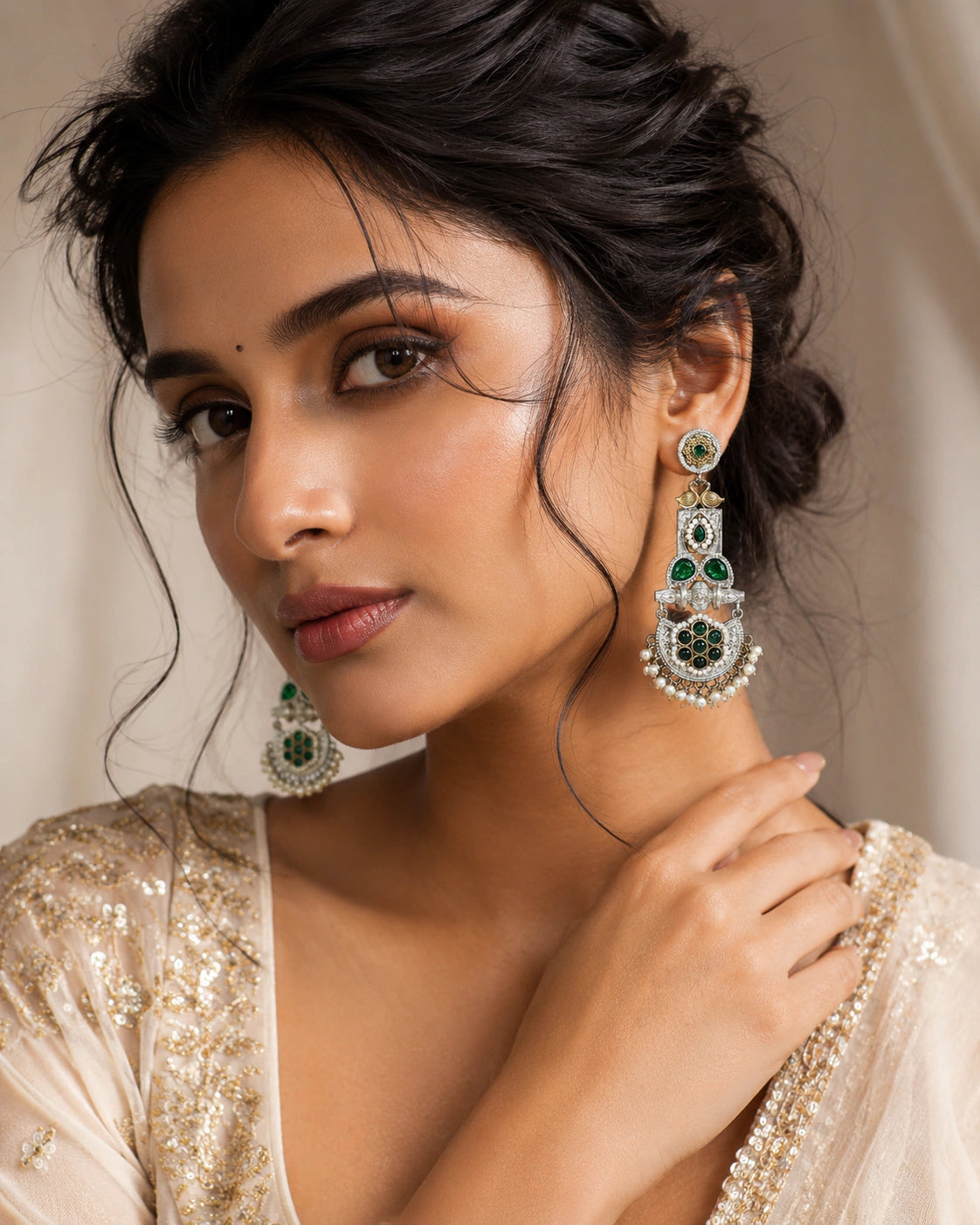German silver green pearl-style peacock chandelier earrings worn by a model
