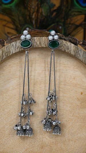 Close-up ear view showing green accents and layered pearl tassels
