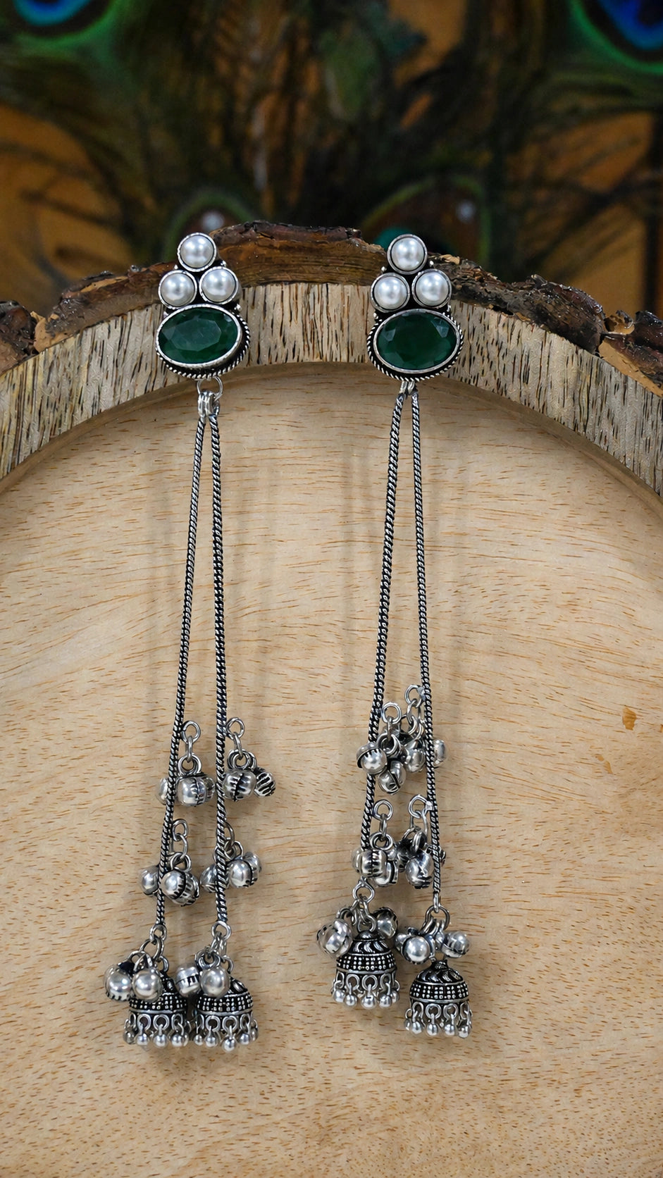 Close-up ear view showing green accents and layered pearl tassels