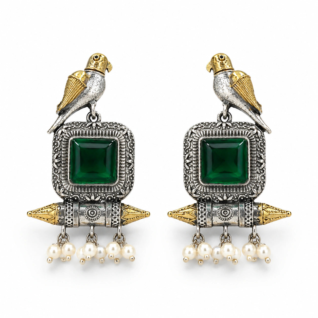 Angled view of German silver green-stone bird pearl dangle earrings