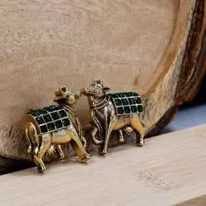 Alternate detail view of green-stone cow-motif earrings