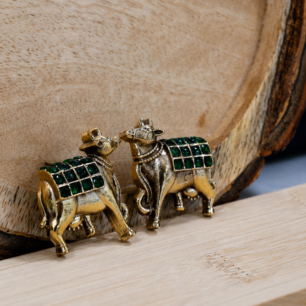Alternate detail view of green-stone cow-motif earrings