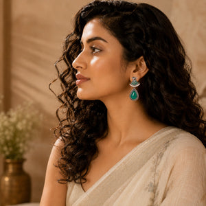 Close-up of green stones, pearl-style beads and German silver dangle detailing