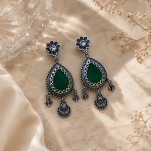 Close-up of green teardrop beads and German silver dangle detailing