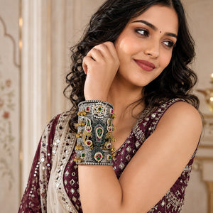 German silver multicolor Kundan bird-motif kada styled in a jewellery flat lay