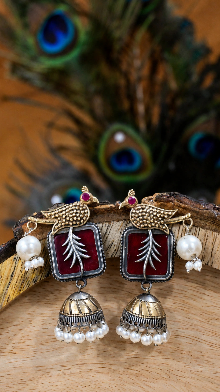 Close-up ear view showing maroon bird motifs and pearl-style jhumka drops